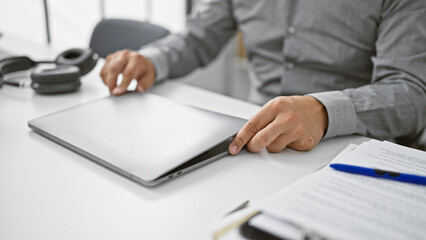 Professional senior man with grey beard engaging in business activities in a modern office setting.