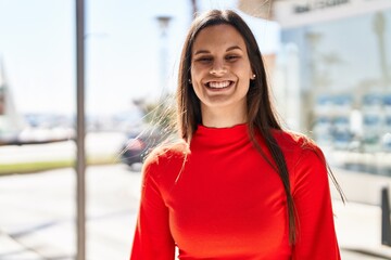 Young beautiful hispanic woman smiling confident standing at street