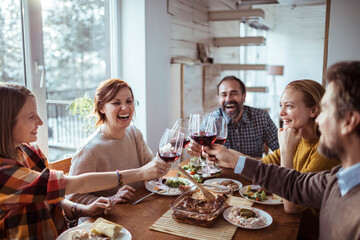 Diverse group of young people having lunch together at home