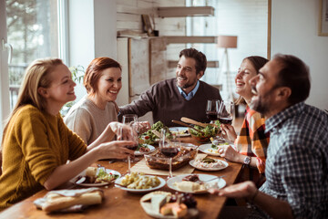 Diverse group of young people having lunch together at home