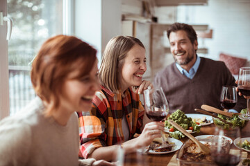 Diverse group of young people having lunch together at home