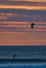A kite surfer surfing during sunset at sunset beach, Milnerton, Cape Town, South Africa