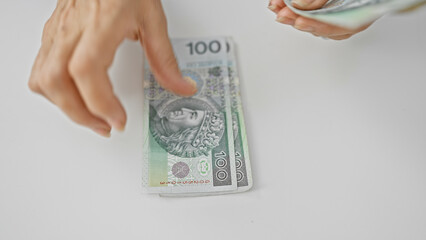 Close-up of female hands counting polish zloty banknotes, symbolizing financial transactions in poland.