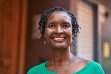 Middle age african american woman smiling confident standing at street
