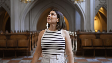 Young beautiful hispanic woman visiting church at Augustinian Church in Vienna