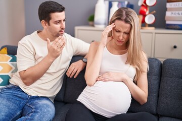 Man and woman couple expecting baby arguing at home