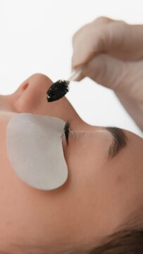 Discover the world of macro beauty by looking at the details of care and makeup routines. The video impresses with its purity and precision in creation beauty. A beautician works with an eyelash brush