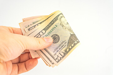 Man hand with dollars isolated on a white background. Businessman gives fifty dollars. Concept of...