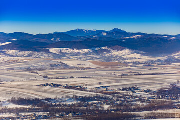Ceahlau mountain in winter landscape. view from Targu Neamt city