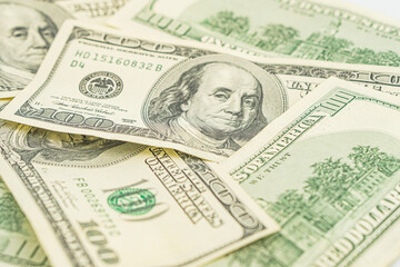 Lots of 100 dollar bills, the concept of US cash money. US paper money. Bribery with a wad of money, cash circulation and money exchange currency. Background of 100 dollar bills