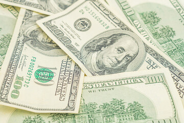 Lots of 100 dollar bills, the concept of US cash money. US paper money. Bribery with a wad of money, cash circulation and money exchange currency. Background of 100 dollar bills