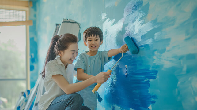 A Boy and a Girl Painting a Wall