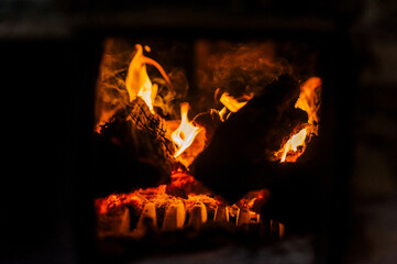 Fire, bonfire, burning wood in the fireplace stove in the house. Close-up photo.