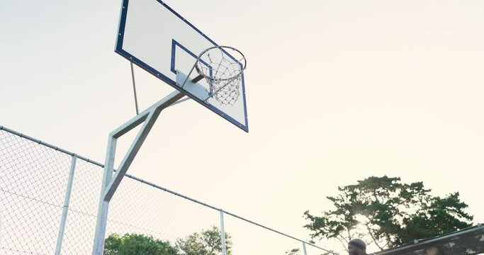 Black people, dunk or basketball court for sports or practice in a challenge with teamwork, speed or score. Men, low angle or exercise in park for fitness training for competition, game or athletes