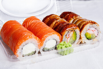 Assorted Sushi Rolls in a Takeout Container