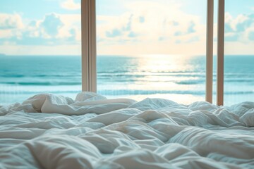 White messy bedding and big window with view to beautiful sea. 