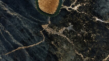 Aerial View of Isolated Water Body in Burnt Landscape