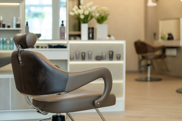 Sophisticated hair salon interior featuring a plush brown hairdressing chair and product shelves with a mirrored backdrop.