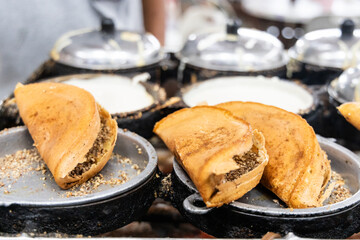Vendor preparing traditional delicious apam balik or peanut pancake in food eatery
