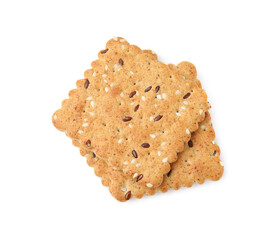 Stack of cereal crackers with flax and sesame seeds isolated on white, top view