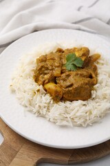 Delicious chicken curry with rice on table, closeup