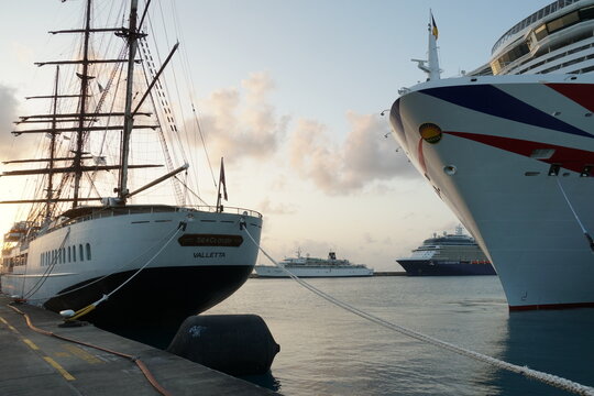 Bridgetown, Barbados 02 02 2024: Aft part of The Sea Cloud II, large barque cruise ship and bow of Arvia passenger vessel of excellence-class moored in Bridgetown, Barbados on the Caribbean island. 