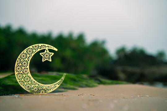 Crescent golden moon on the beach Eid Mubarak concept image, golden moon with star 2025 Eid Mubarak greeting background