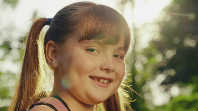 happy little girl smiling looking camera, child portrait, child girl face smile sunset, children smile park sunset, girl daughter laughing, summer bokeh background, schoolgirl face close-up