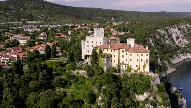 drone flying over duino's castle near to the sea in trieste