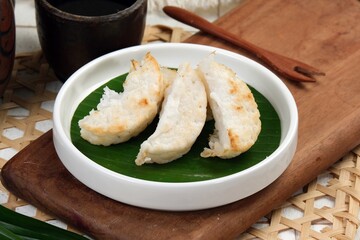 Kue Pancong or kue Gandos or Bandros cake is an Indonesian traditional snack made from a mixture of...