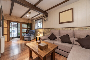 A small living room on the ground floor of a detached house with fabric upholstered sofas