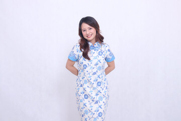 Beautiful smiling asian woman wearing modern chinese dress hands back isolated on white background. happy Chinese New Year