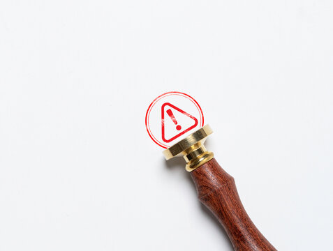 Rubber stamp with red triangle exclamation caution sign symbol for warning notification of dangerous error and maintenance concept.