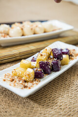 Taiwanese traditional sweet and dessert, glutinous rice dumplings and sweet potato dumplings with coconut sugar and peanuts and coconut flakes