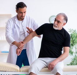 Old injured man visiting young doctor