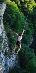 Bungie jumper jumping off bridge with bungie cord attached