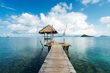 A long wooden bridge in a beautiful turquoise sea. There is a beer and beverage bar to serve...