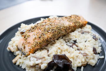 Salmon on top of risotto.