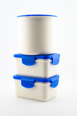 set of white plastic containers and food thermos with blue lid for lunch