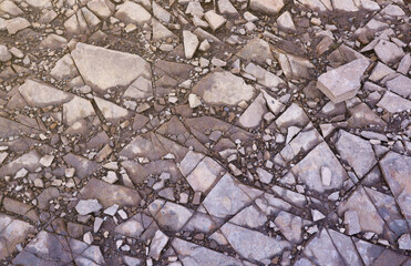 Background of shattered stony stones surface in mountain area. Flat texture with natural light