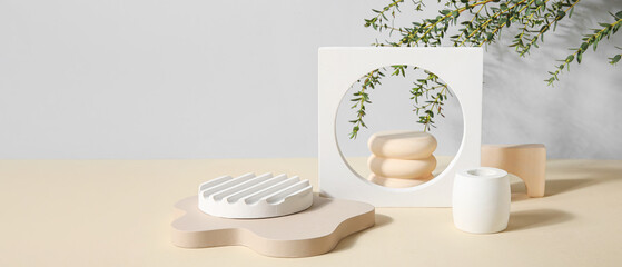 Plaster podiums and eucalyptus branches on color background with space for text