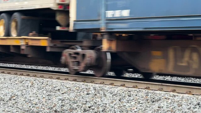 cargo train moving over train tracks at high speeds telephoto