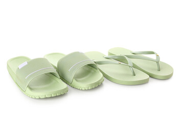 Colorful pairs of female flip flops on white background