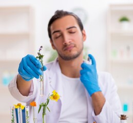 Young male chemist in perfume synthesis concept