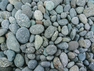 Pebbles stacked in the seaside. background.