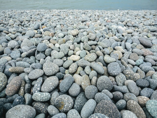 Pebbles stacked in the seaside. background.