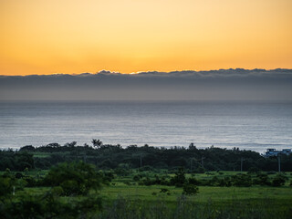 Sunrise over the sea, golden-hued scenery.	