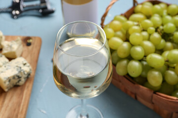 Glass of exquisite wine on blue background
