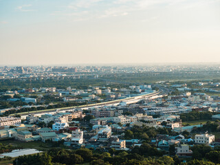 View of city from the beautiful mountain. Blue sky and green meadow.