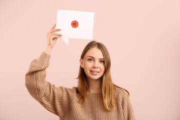 Pretty young woman holding speech bubble with +1 icon on pink background. New message